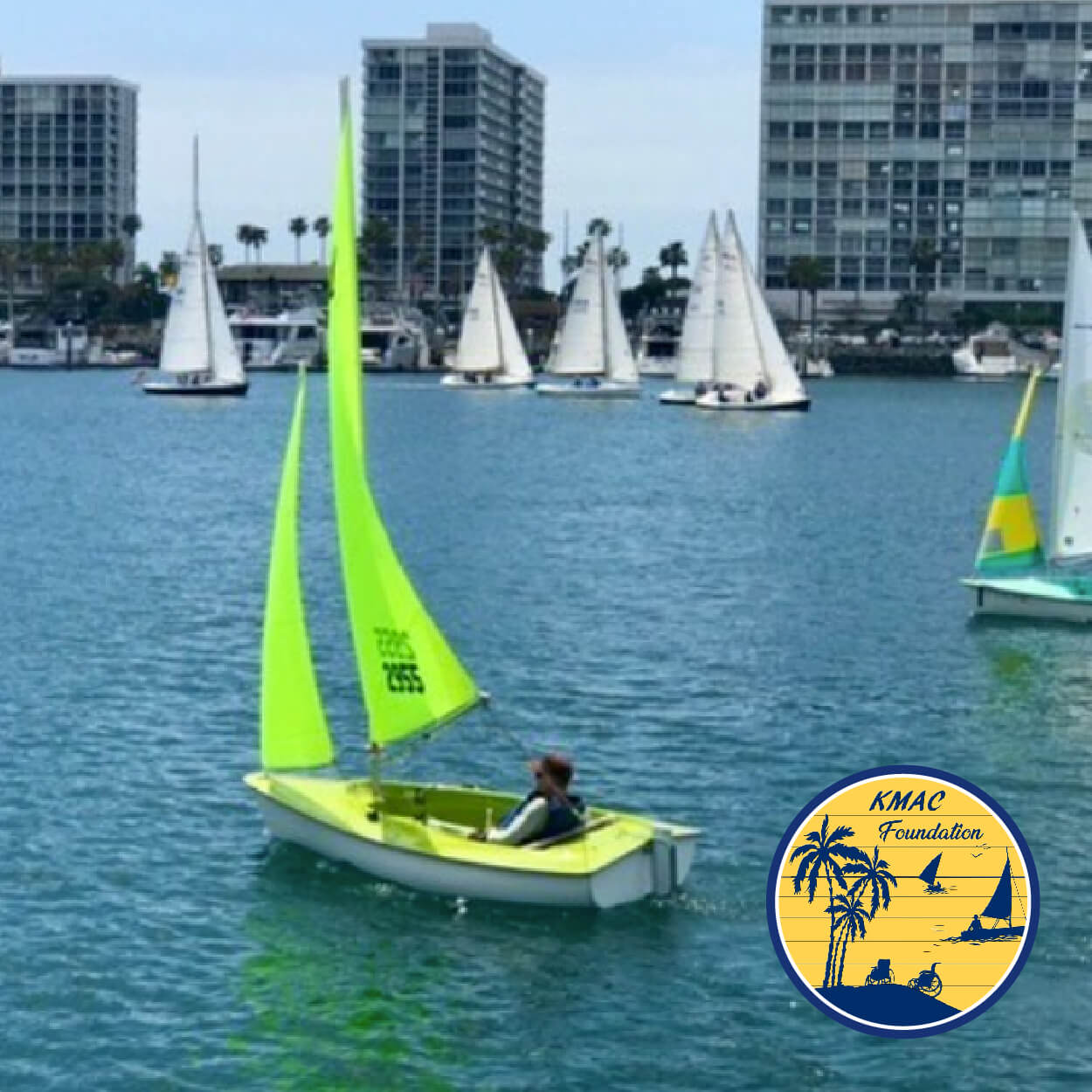 KMAC foundation image - neon green sailboat in the water