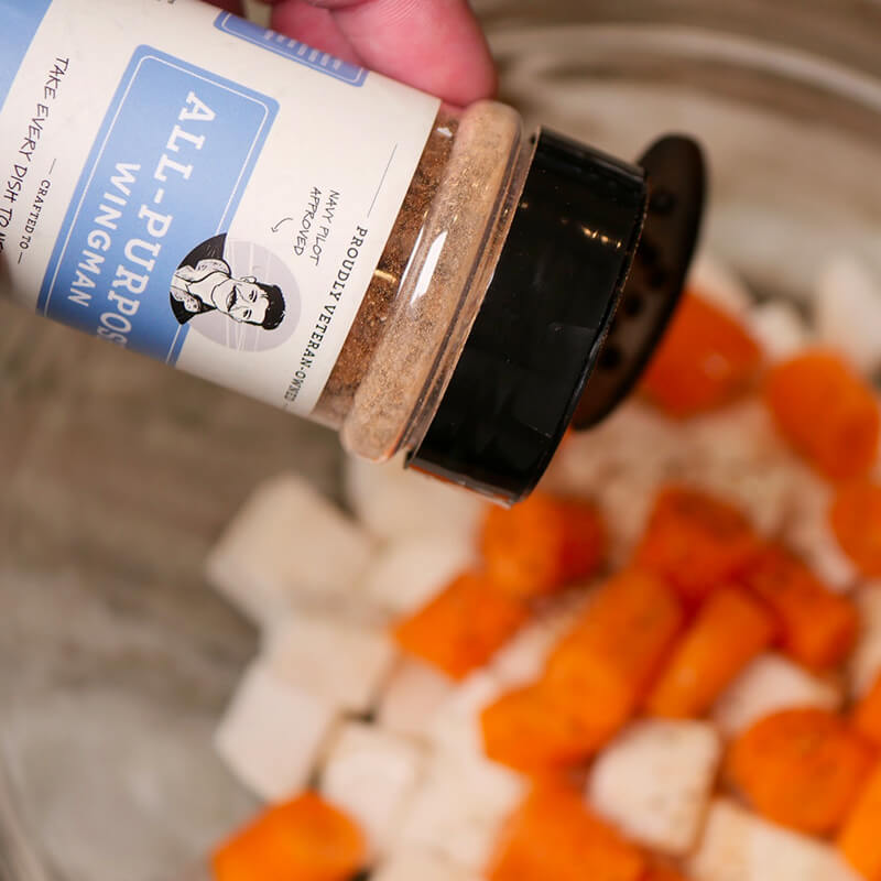 Hangar Bay Spice Co. Wingman All-Purpose seasoning being added to carrots and potatoes